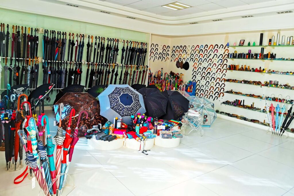 Umbrella sample showroom displaying open canopies, folded umbrellas and handle samples.