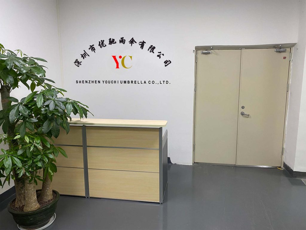 Reception area with Shenzhen Youchi Umbrella Co., Ltd. signage on the wall.